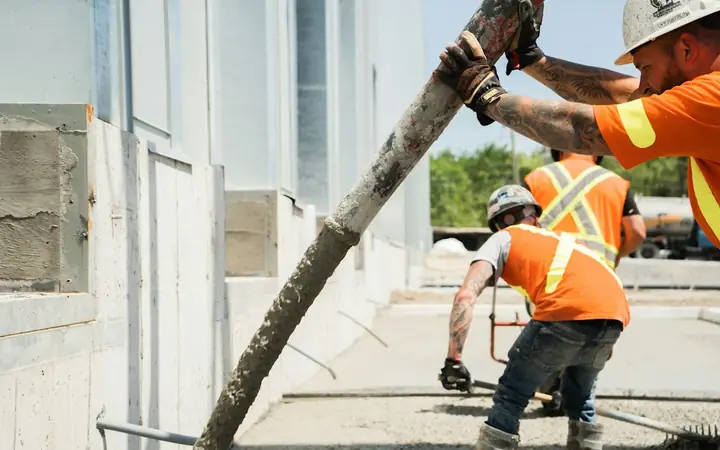 Construction crew in safety vests repairing concrete