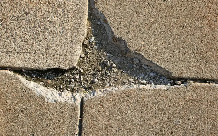 Heaved and broken sidewalk slab