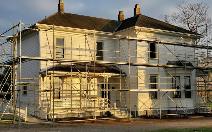 House exterior wrapped in scaffolding during renovation