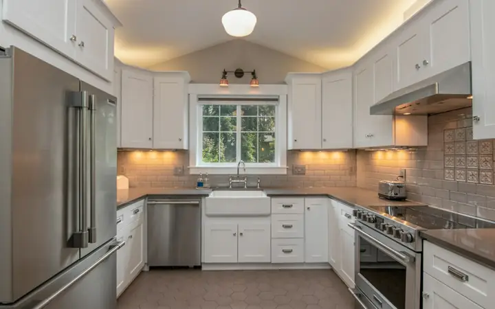 White shaker kitchen cabinets with under-cabinet lighting