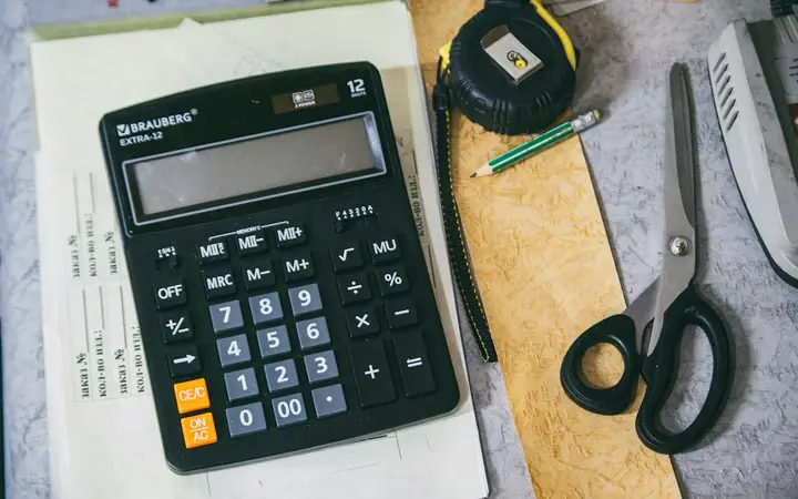Calculator, tape measure and notes for planning a renovation budget