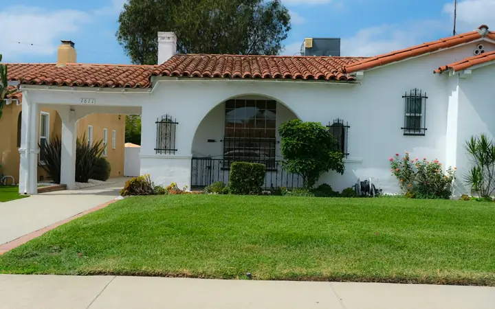 White stucco house with a red tile roof