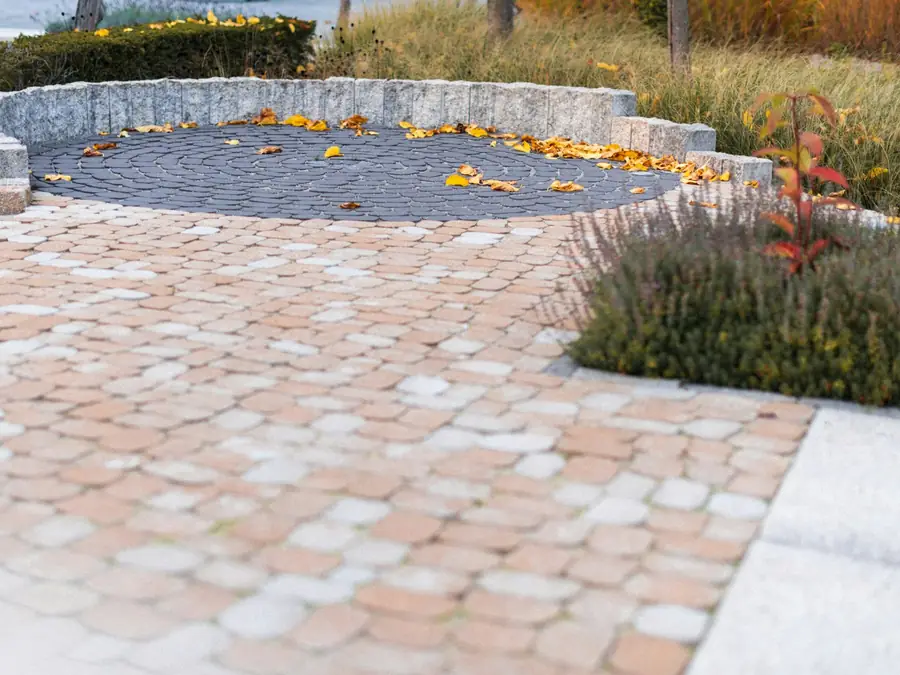 Paver patio with a curved stone seating wall