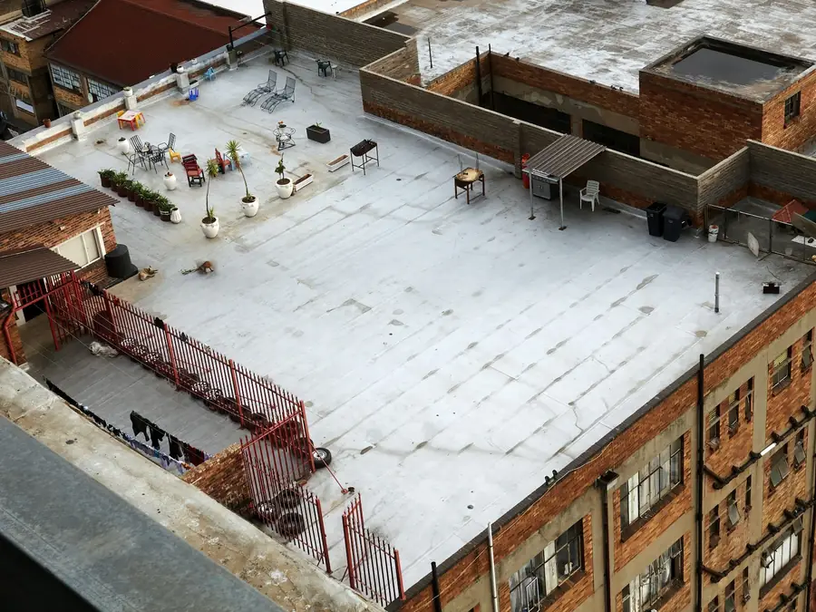 Aerial view of a coated flat roof on a brick apartment building